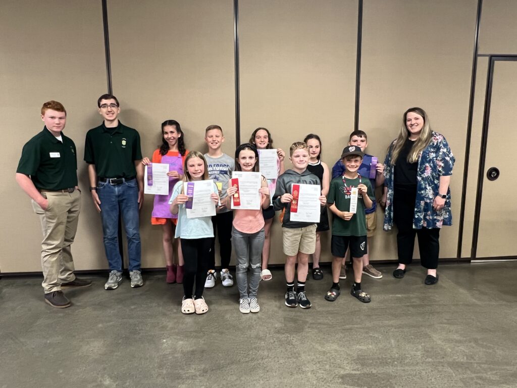 4-H youth displaying ribbons from the 4-H County Demonstration Contest