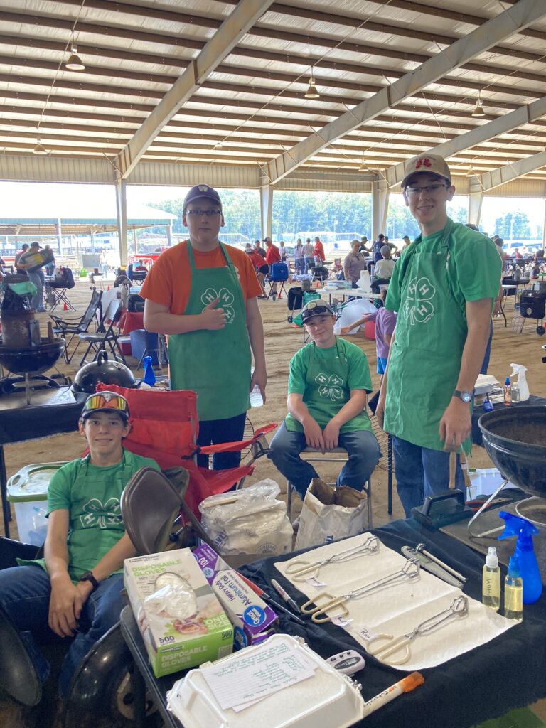 4-H youth sitting, preparing for a cooking contest.