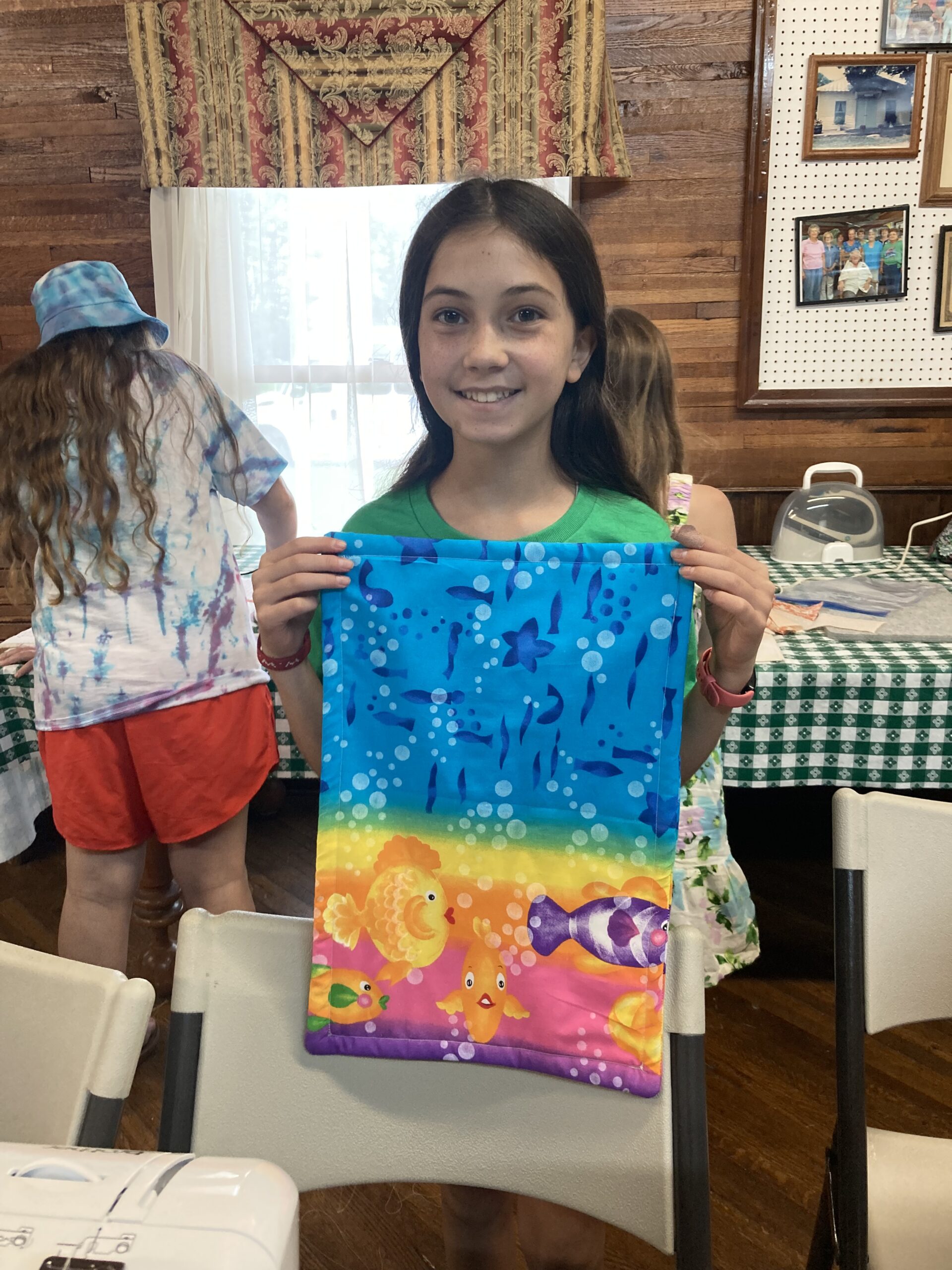 4-Her's displaying a colorful handbag made by hand.