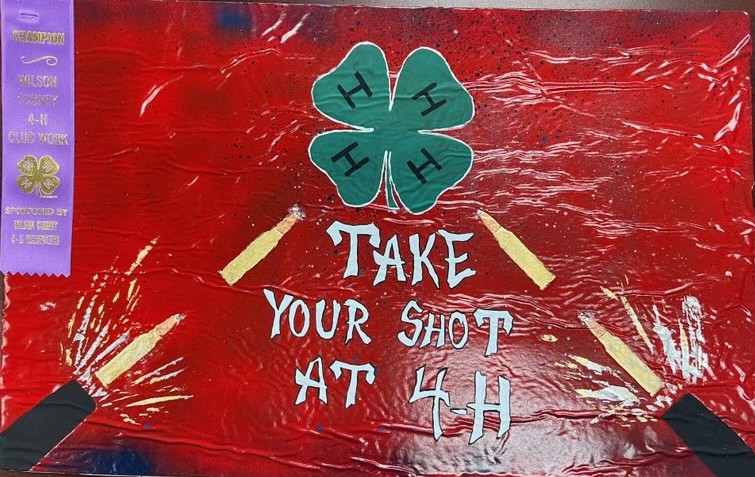 Red 4-H poster with Take your shot at 4-H caption.