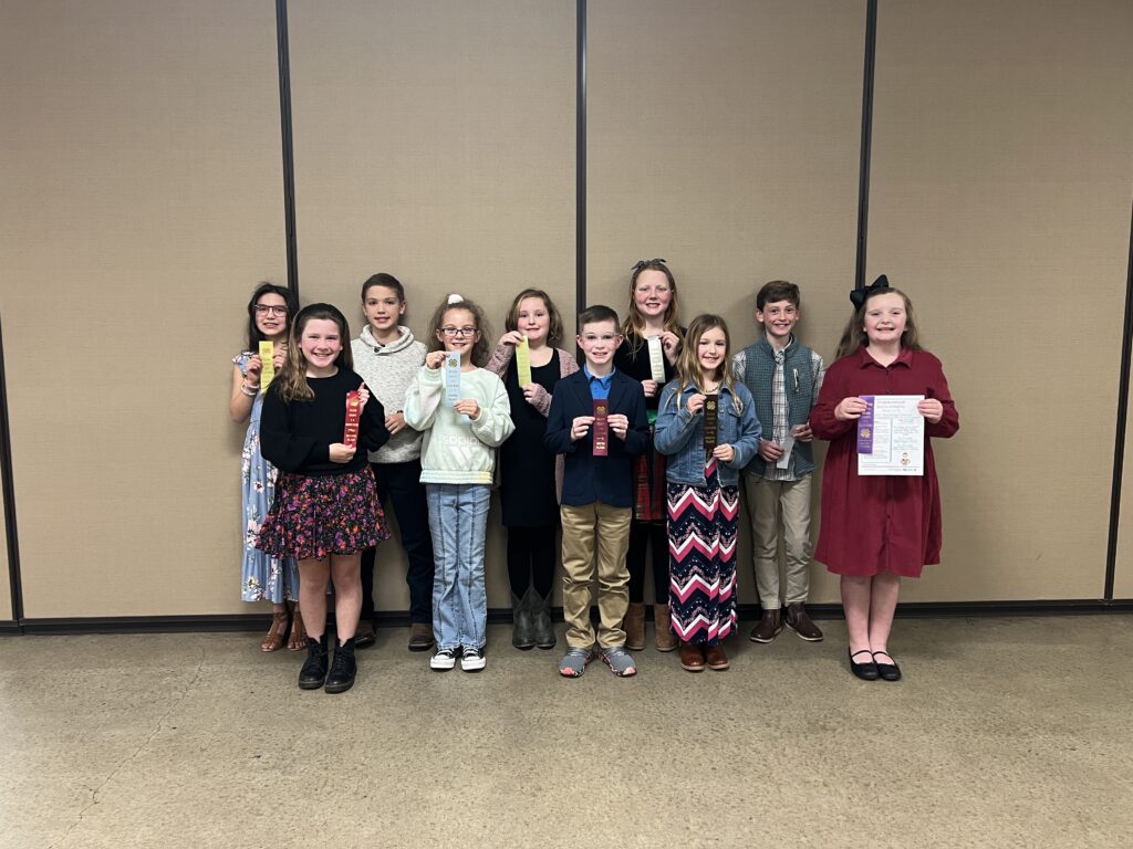 4-H youth holding ribbons